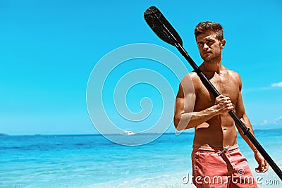 Summer Water Sport. Man With Canoe Kayak Paddle On Beach Stock Photo