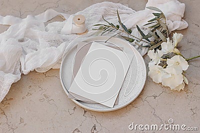 Summer wedding stationery. Birthday mock-up scene. Blank greeting cards on plate. White oleander blossom, ribbon and Stock Photo