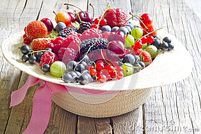 Summer wild berry fruits in the hat concept Stock Photo