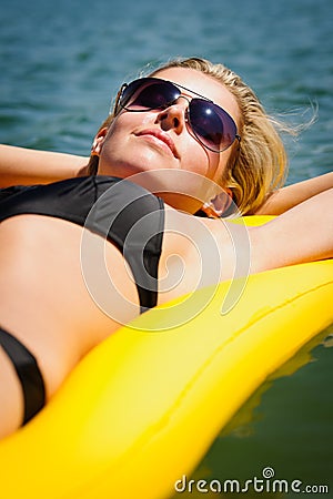 Summer woman relax on water floating mattress Stock Photo