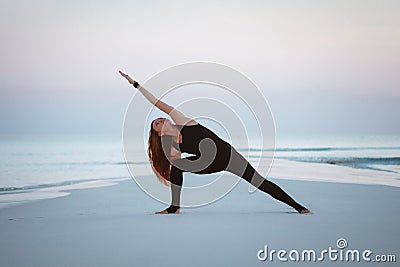 Summer yoga session on a beautiful golden beach of Maldives yoga tour, Extended Side Angle Pose Utthita Parsvakonasana Stock Photo