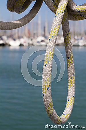 Summertime closeup of sailing rope with sailing boats in harbour Stock Photo