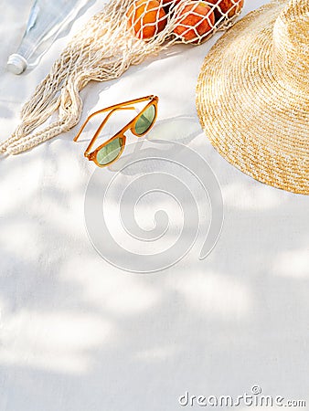 Beach accessories, exotic fruit and a bottle of water on the white background. Stock Photo