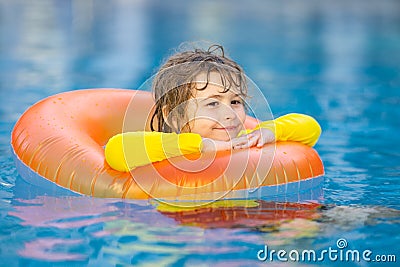 Summertime fun. Little kid swimming in pool. Kid in swimming pool relax and swim on inflatable ring. Summer vacation Stock Photo