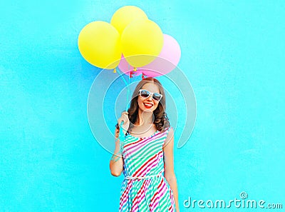 Summertime! happy smiling woman holds in hand an air colorful balloons Stock Photo