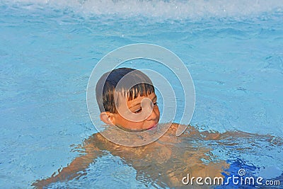 Summertime and swimming activities for happy children in the pool. Cute boy in water park. Summer and happy chilhood concept Stock Photo