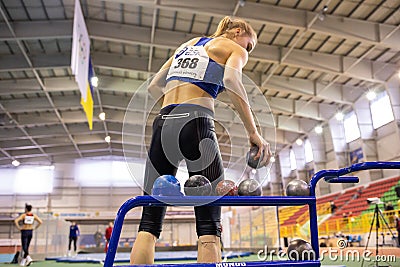 SUMY, UKRAINE - FEBRUARY 21, 2020: Alina Shukh pentathlon champion in shot put sector at Ukrainian indoor track and Editorial Stock Photo