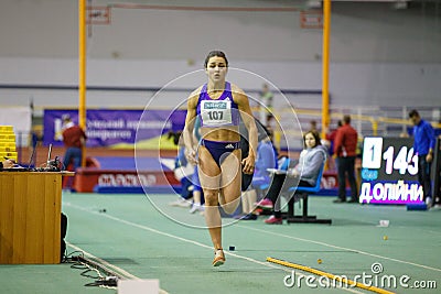 SUMY, UKRAINE - FEBRUARY 9, 2018: Rimma Hordiyenko - win second place performing long jump attempt in pentathlon Editorial Stock Photo