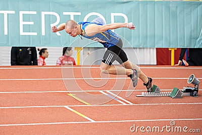 SUMY, UKRAINE - FEBRUARY 21, 2020: sportsman at the start of 200m race at Ukrainian indoor track and field championship Editorial Stock Photo
