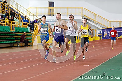 SUMY, UKRAINE - FEBRUARY 17, 2017: sportsmen running qualification race in the men`s 400m running in an indoor track and Editorial Stock Photo