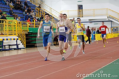 SUMY, UKRAINE - FEBRUARY 17, 2017: sportsmen running qualification race in the men`s 400m running in an indoor track and Editorial Stock Photo