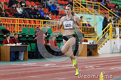 SUMY, UKRAINE - FEBRUARY 17, 2017: Viktoria Tkachuk#140 running in the women`s 400m running in an indoor track and Editorial Stock Photo