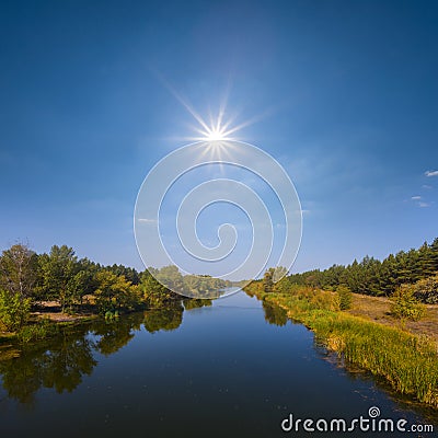 Sun above long irrigational channel Stock Photo