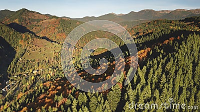 Sun autumn mountain trees at ranges. Aerial nobody nature landscape. Road at mount valley village Stock Photo