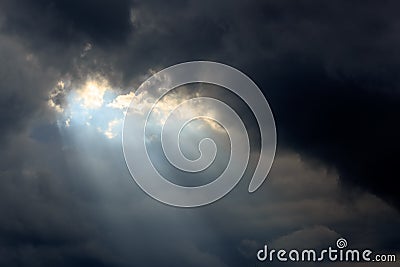 Sun Beam in Dark Clouds and Sky Stock Photo