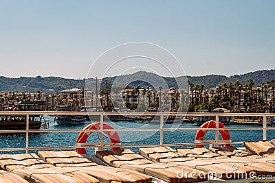 Sun beds and lifebuoys on the ship Stock Photo