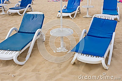 Sun beds on a sandy beach. Stock Photo