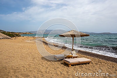 Sun beds and umbrellas at Soros beach on Antiparos Stock Photo