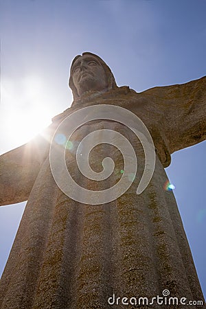 Sun behind Christus Rei Statue in Lisbon, Portugal Stock Photo