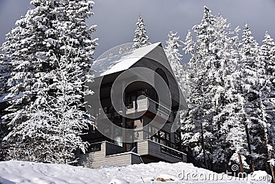 Sun Breaks on a Snowy Whitefish Mountain Resort Chalet Stock Photo