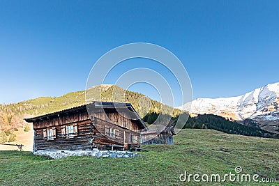 Sun burned timber chalet hut on austrian mountains Stock Photo