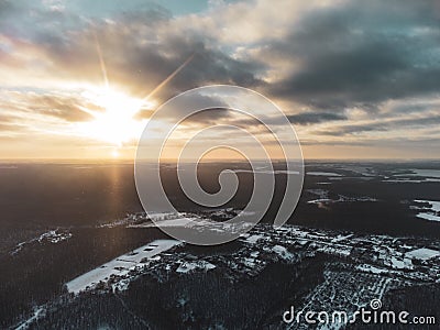 Sun in clouds, winter aerial snowy countryside Stock Photo