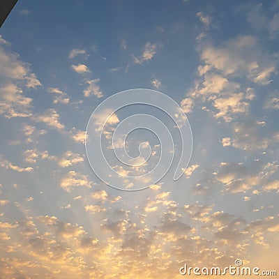 The sun coming out after rain,it`s rays spreading through the clouds. Stock Photo