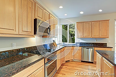 Sun filled gourmet kitchen with wooden cabinetry Stock Photo