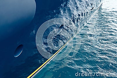 Sun glare on glossy board of mega yacht, anchor, tranquillity in port Hercules, bow of moored huge boat at sunny day Stock Photo