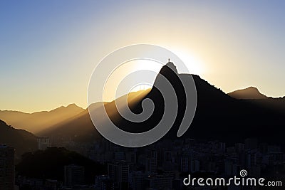 Sun light behind Mountain Corcovado Christ the Redeemer, sunset, Rio de Janeiro Editorial Stock Photo