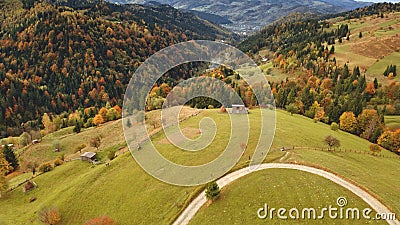 Sun mountain road aerial. Autumn nobody nature landscape. Village at mist haze. Countryside forest Stock Photo