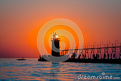 Sun perfectly framed in South Haven`s lighthouse at sunset in Michigan Editorial Stock Photo