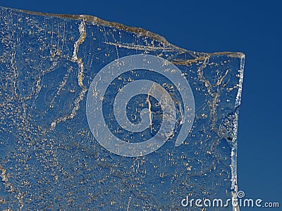 Sun rays caught in cracks in ice piece. Broken floe Stock Photo