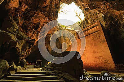 Sun rays fall into the cave with a big staircase Stock Photo