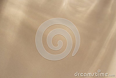 Sun rays falling from a window from different directions,creating diagonal lines on a beige wall. Stock Photo