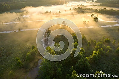 Sun rays on foggy summer meadow aerial view. Vivid nature landscape in sunlight view from above. Amazing sunny river nature with Stock Photo