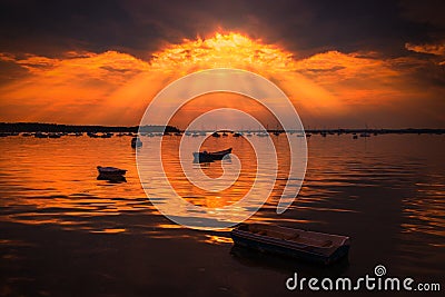 Sun rays illuminate boats in Poole Harbour Stock Photo