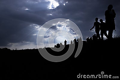 Immigration of people and dark clouds Stock Photo