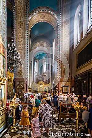 Sun rays shining in through church window on worshippers praying in the Russioan Orthodox Cathedral in Tallinn, Estonia Editorial Stock Photo