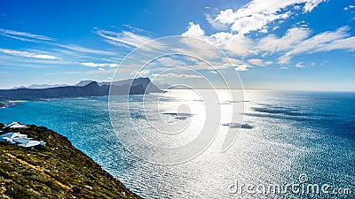 Sun reflecting of the waters of False Bay with Swartkopberg near Simons Town in the distant Stock Photo