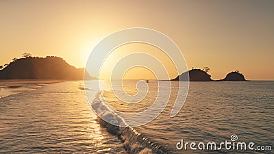 Sun reflection at waves of ocean bay aerial. Silhouette of mountains islands with tropic seascape Stock Photo