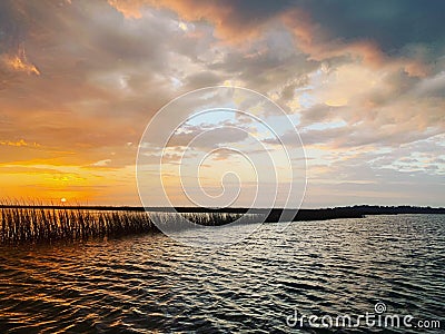 Sunrise over the inlet on a cloudy day creating awesome colors in the clouds Stock Photo