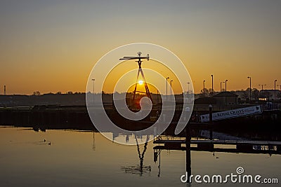 Sun rise over the River Tyne and Weather Vane Stock Photo