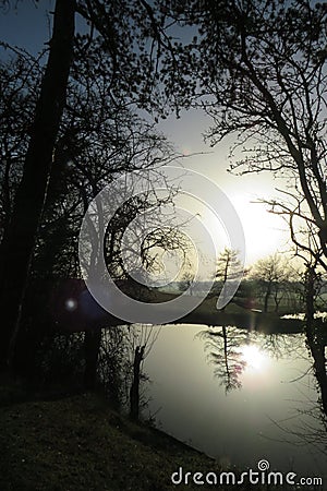 Sun rise sun set reflections of water and trees in rugby Warwickshire Stock Photo