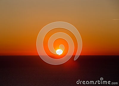 Sun rises over sea Stock Photo