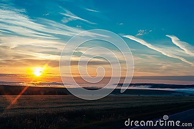 Sun Rising Above Asphalt Open Road In Sunny Sunrise Morning Stock Photo