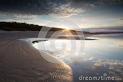 The sun rising above the river. Stock Photo