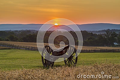 Sun rising behind artillery near a wheat field at Antietam Stock Photo