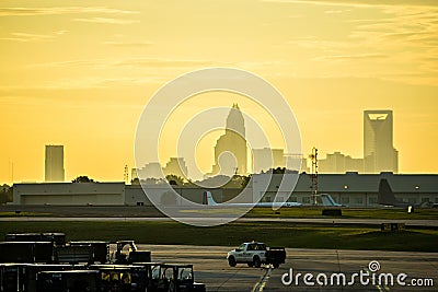 sun rising early morning over charlotte skyline seen from clt ai Editorial Stock Photo