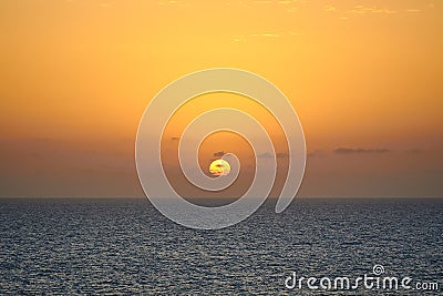 Sun rising at a sunrise above the sea Stock Photo